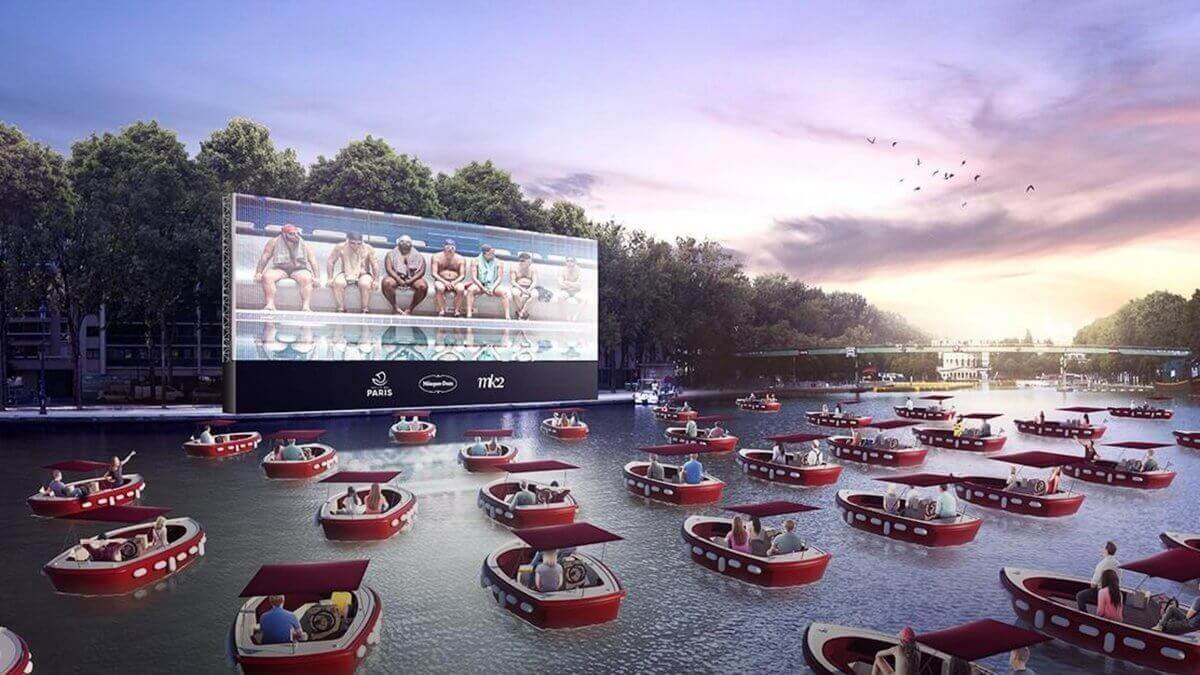 Boats on a river watching a cinema screen in Paris